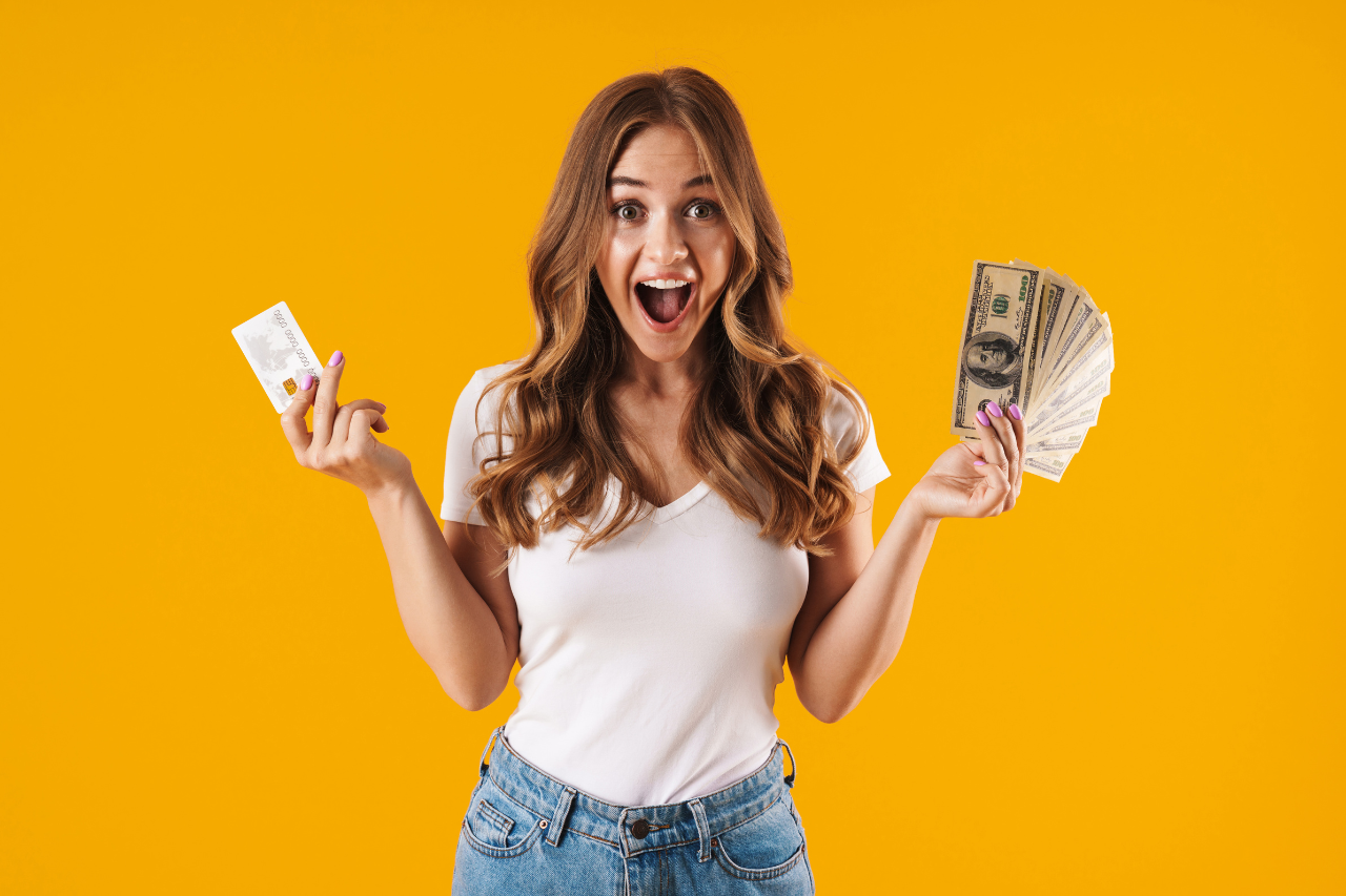 Excited woman holding cash after getting approved for a personal loan through Nexus Loan Hub